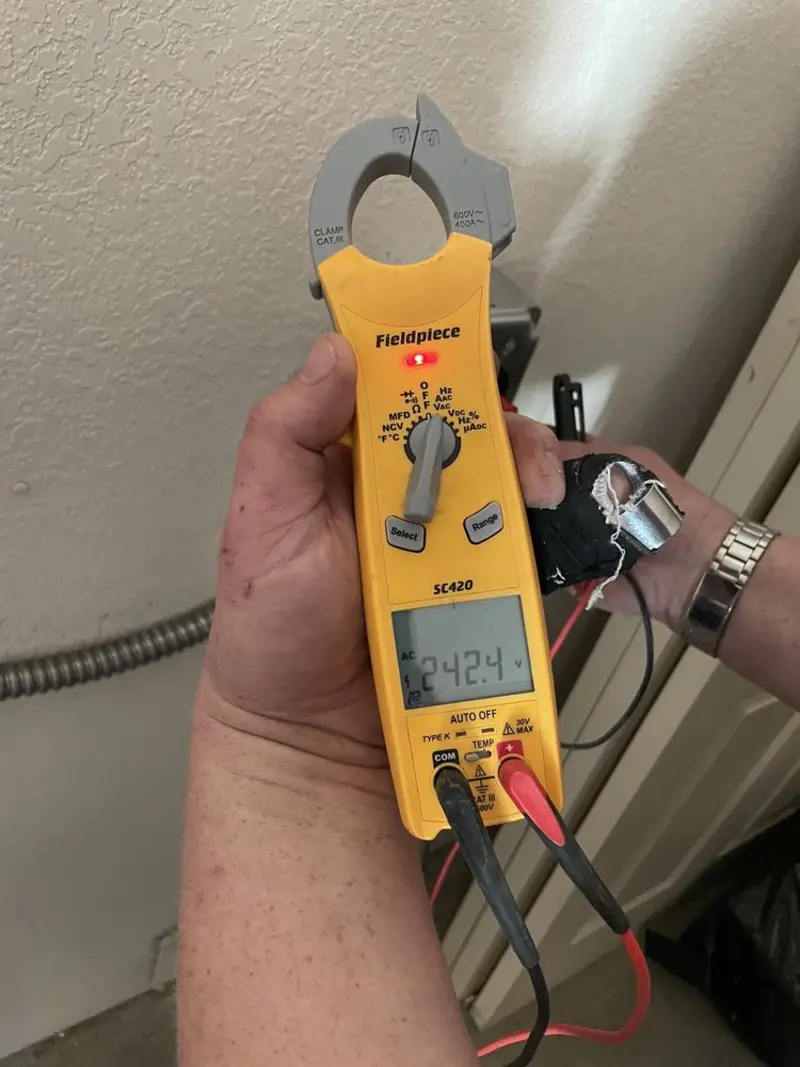 Voltage testing with clamp meter during Outlet Installation in Indio